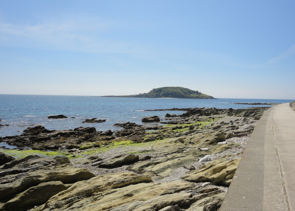 Hannafore Beach with Looe Island Nature Reserve in the background.