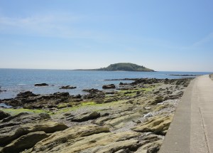 Hannafore Beach with Looe Island Nature Reserve in the background.