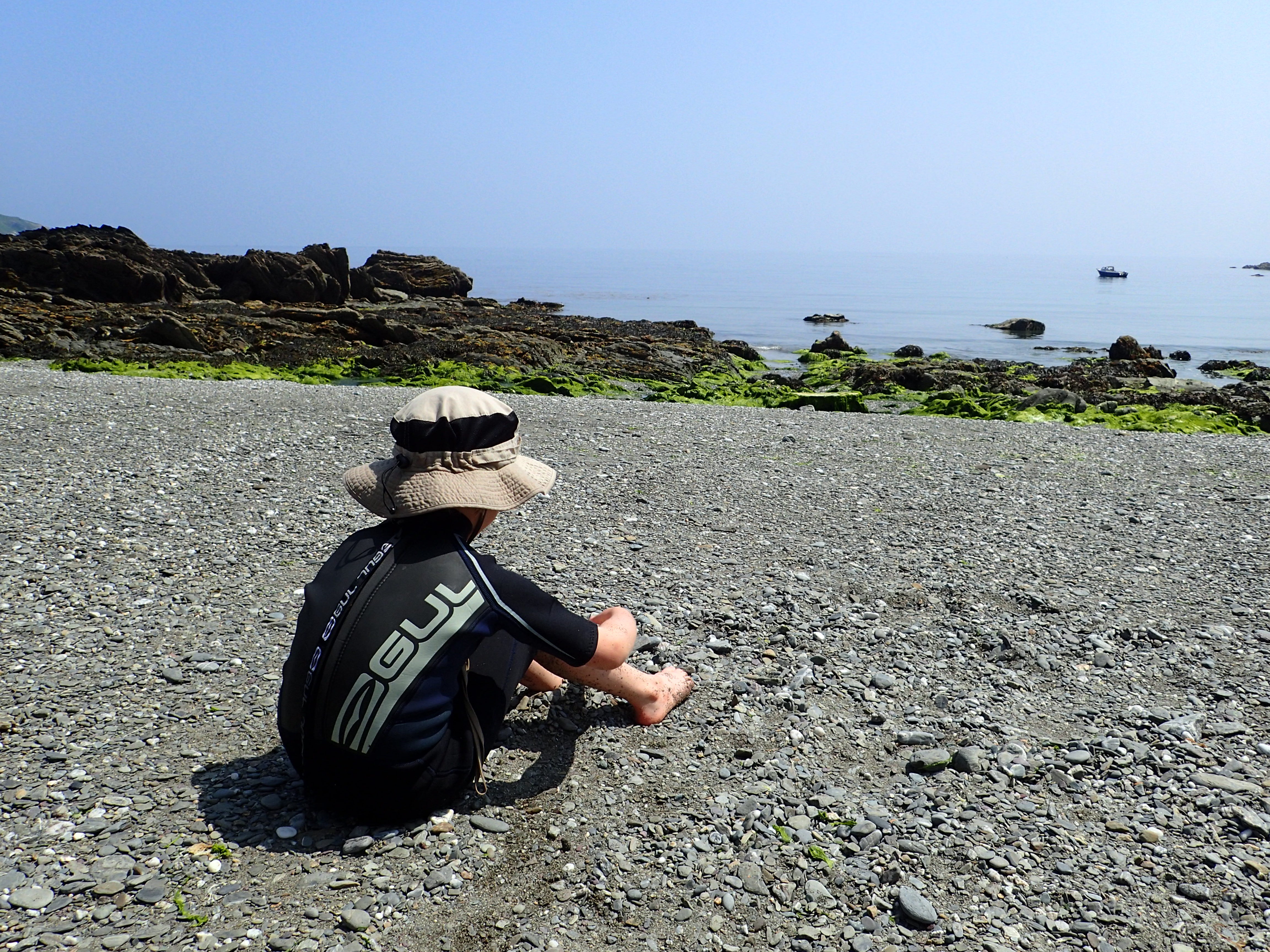Cornish Rock Pools junior drying off in the sunshine at Port Nadler, near Looe.